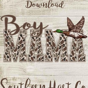 May include: A brown and tan camouflage print design with the words "Boy Mama" in brown text. A green-headed duck with brown and white feathers is flying above the text. The words "Southern Hart Co." are in brown text at the bottom of the design.