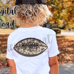 May include: White t-shirt featuring a camouflage football design. The shirt has the text "Southern Heart Co" vertically on the right and "Png Digital Download" on the left side.