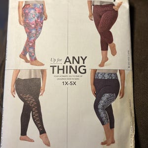 May include: A Simplicity sewing pattern envelope 8327 for leggings in sizes 1X-5X. The cover displays four variations: colorful patterned leggings, maroon capris, black leggings with lace side panels, and dark capris with snake print panels.