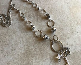 Long silver bauble necklace with key charms and silver beads