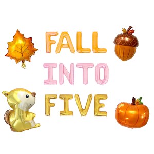 May include: A set of foil balloons featuring the text FALL INTO FIVE in orange, pink, and gold. The set includes a maple leaf balloon, an acorn balloon, a squirrel balloon, and a pumpkin balloon, all arranged to celebrate a fifth birthday.