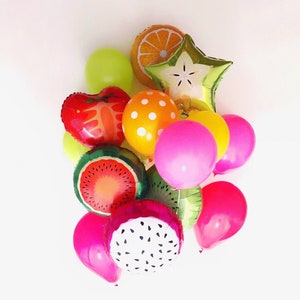 May include: A collection of colorful balloons including round latex balloons in lime green, yellow, and hot pink, alongside foil balloons shaped like a strawberry, orange slice, starfruit, watermelon slice, kiwi slice, and dragon fruit.