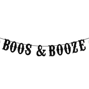 May include: A black glittery banner featuring the text BOOS & BOOZE in a decorative font, strung on a thin black cord. The banner is flanked on both ends by a white glittery ghost cutout, creating a festive hanging decoration for events.
