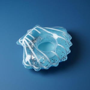 May include: An inflatable light blue drink holder shaped like a seashell. The translucent plastic features white line details radiating from the center and is filled with loose silver glitter particles that move within the clear sections of the shell.