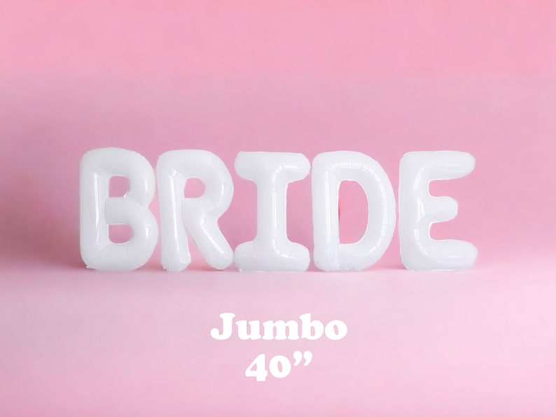 May include: White inflatable balloons spelling out the word "BRIDE" against a pink background. The text "Jumbo 40"" is displayed below the balloons. Ideal for a bridal shower or wedding.