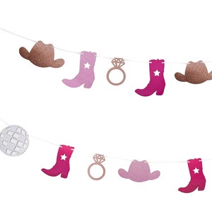 May include: A decorative banner with glittery cutouts of cowboy hats, boots with stars, a disco ball, and engagement rings. The colour palette includes shades of pink, rose gold, and brown, strung on white string.