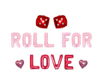 May include: A festive arrangement of foil balloons spelling out "ROLL FOR LOVE" with two red dice balloons and two heart-shaped balloons. The letters are pink and red, perfect for a romantic celebration.