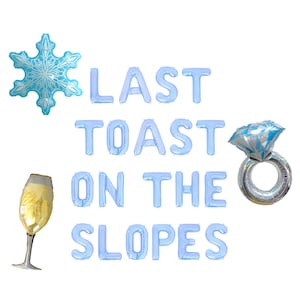 May include: Blue balloon letters spelling "Last Toast on the Slopes" with a blue snowflake and a silver ring with a blue diamond balloon.