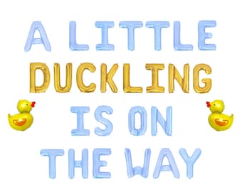 May include: A festive balloon arrangement spells out "A LITTLE DUCKLING IS ON THE WAY" in blue and gold. Two yellow duck-shaped balloons flank the text, creating a celebratory theme, perfect for a baby shower or gender reveal.