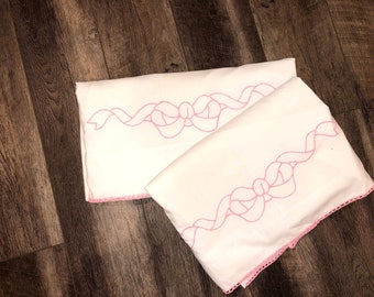 Vintage 1970s embroidered twin sheets with pink ribbon and hem