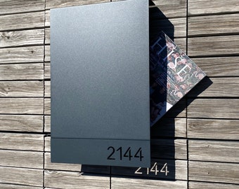 Custom house numbers on modern gray locking wall mounted mailbox as new home gift