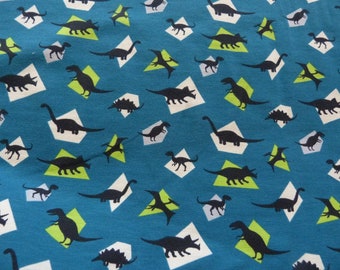Blue Jersey with patterns of dinosaurs in 150 cm, sold by the yard