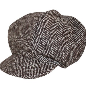May include: A brown and white herringbone patterned newsboy cap.