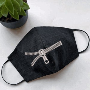 May include: Black face mask with a silver zipper design.