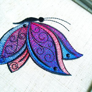 May include: Embroidered butterfly design with blue, purple, and red colors. The butterfly has intricate details and a black outline.
