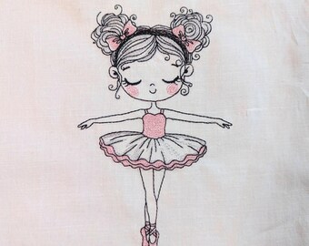 May include: Embroidered illustration of a ballerina in a pink tutu and ballet shoes. The ballerina has her arms outstretched and is wearing a pink leotard. Her hair is styled in two buns with pink bows. The design is stitched on a white background.