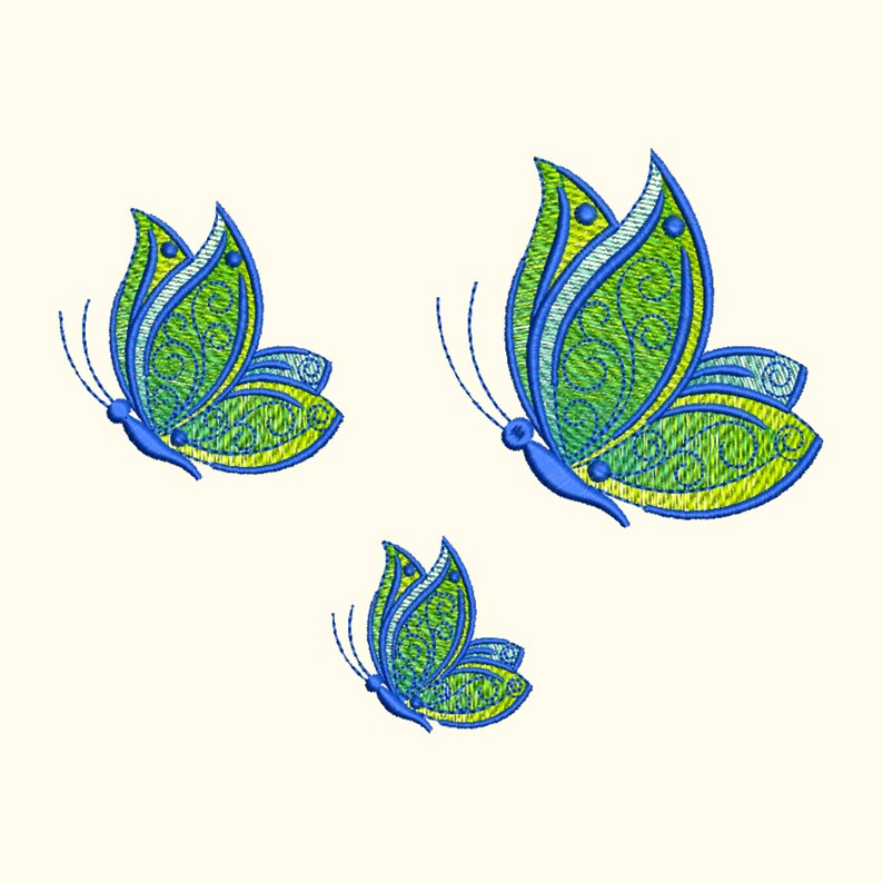 May include: Three embroidered butterflies with green and blue wings. The butterflies are in flight and have a decorative, swirling pattern.
