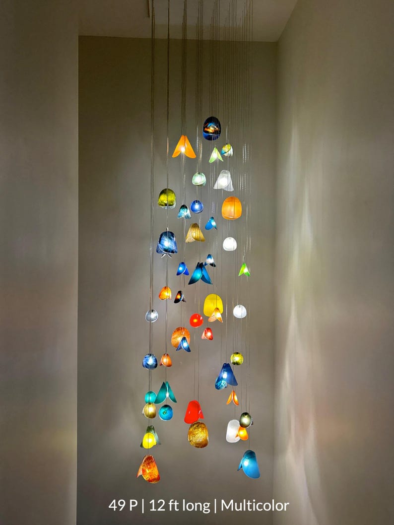 a collection of colorful glass or ceramic objects suspended from the ceiling, creating a visually striking display.