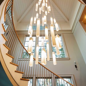 a spiral staircase with a chandelier hanging from the ceiling