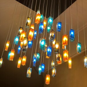 a collection of colorful glass pendant lights suspended from the ceiling, creating a visually striking and vibrant display.