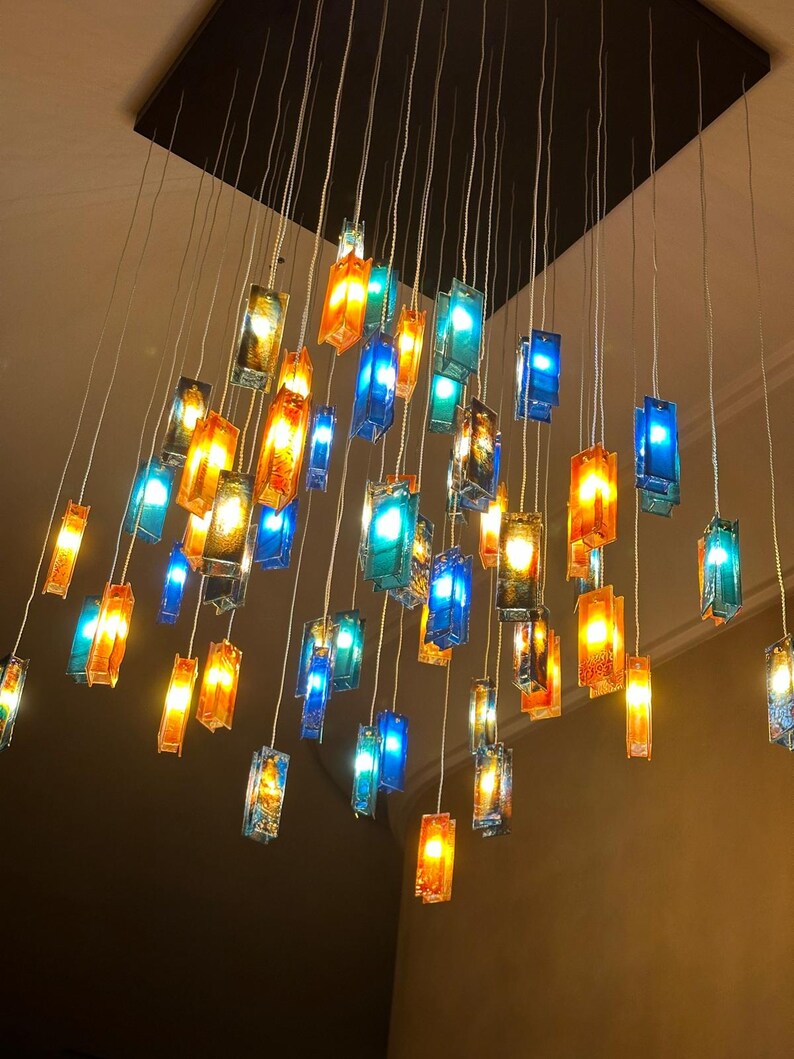 a collection of colorful glass pendant lights suspended from the ceiling, creating a visually striking and vibrant display.
