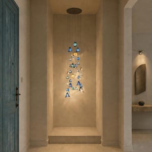 May include: A multi-pendant chandelier featuring numerous small, bell-shaped glass shades in varying shades of blue, teal, and clear glass. The pendants are suspended at different heights from a circular ceiling mount, creating a cascading effect.