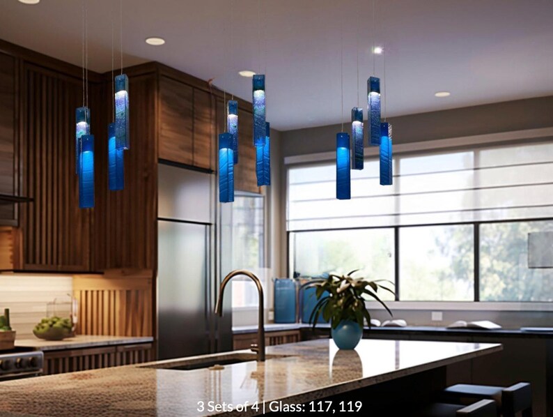 a modern kitchen with a large island, a sink, and a variety of blue pendant lights hanging above it. The kitchen has wooden cabinets and a large window that provides natural light.