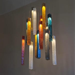 a collection of colorful glass pendant lights suspended from the ceiling, creating a visually striking and vibrant display.