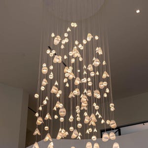 a chandelier made of glass balls hanging from the ceiling