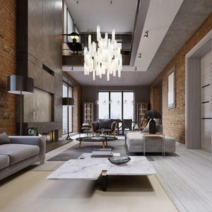 May include: A large, multi-tiered chandelier with numerous vertical, frosted glass rectangular rods suspended from the ceiling, emitting a bright white light in a spacious living room with exposed brick walls and a white marble coffee table.