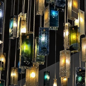 a collection of hanging glass panels with various colors and shapes, creating a visually striking and intricate display.