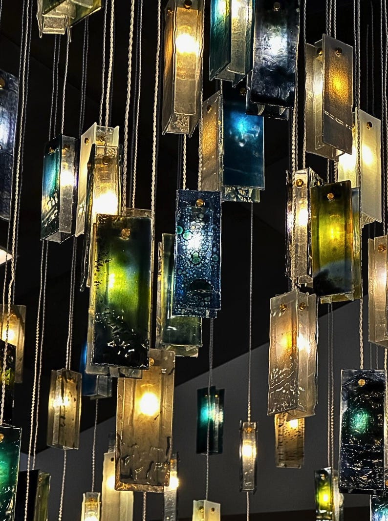 a collection of hanging glass panels with various colors and shapes, creating a visually striking and intricate display.