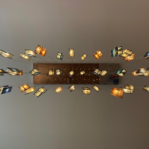 a collection of colorful glass sculptures suspended from the ceiling, creating a visually striking and artistic display.