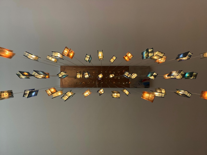 a collection of colorful glass sculptures suspended from the ceiling, creating a visually striking and artistic display.