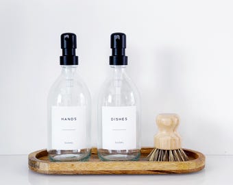 Set Of 2 Clear Bottles - Glass Or Plastic - Hands & Dishes - Black Metal Pumps