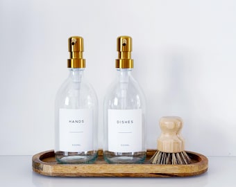 Set Of 2 Clear Bottles - Glass Or Plastic - Hands & Dishes - Gold Metal Pumps
