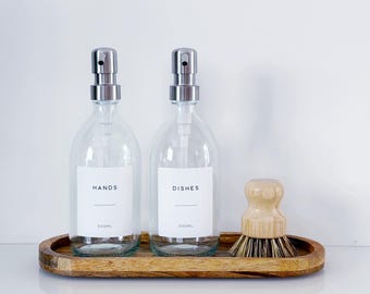 Set Of 2 Clear Bottles - Glass Or Plastic - Hands & Dishes - Silver Metal Pumps