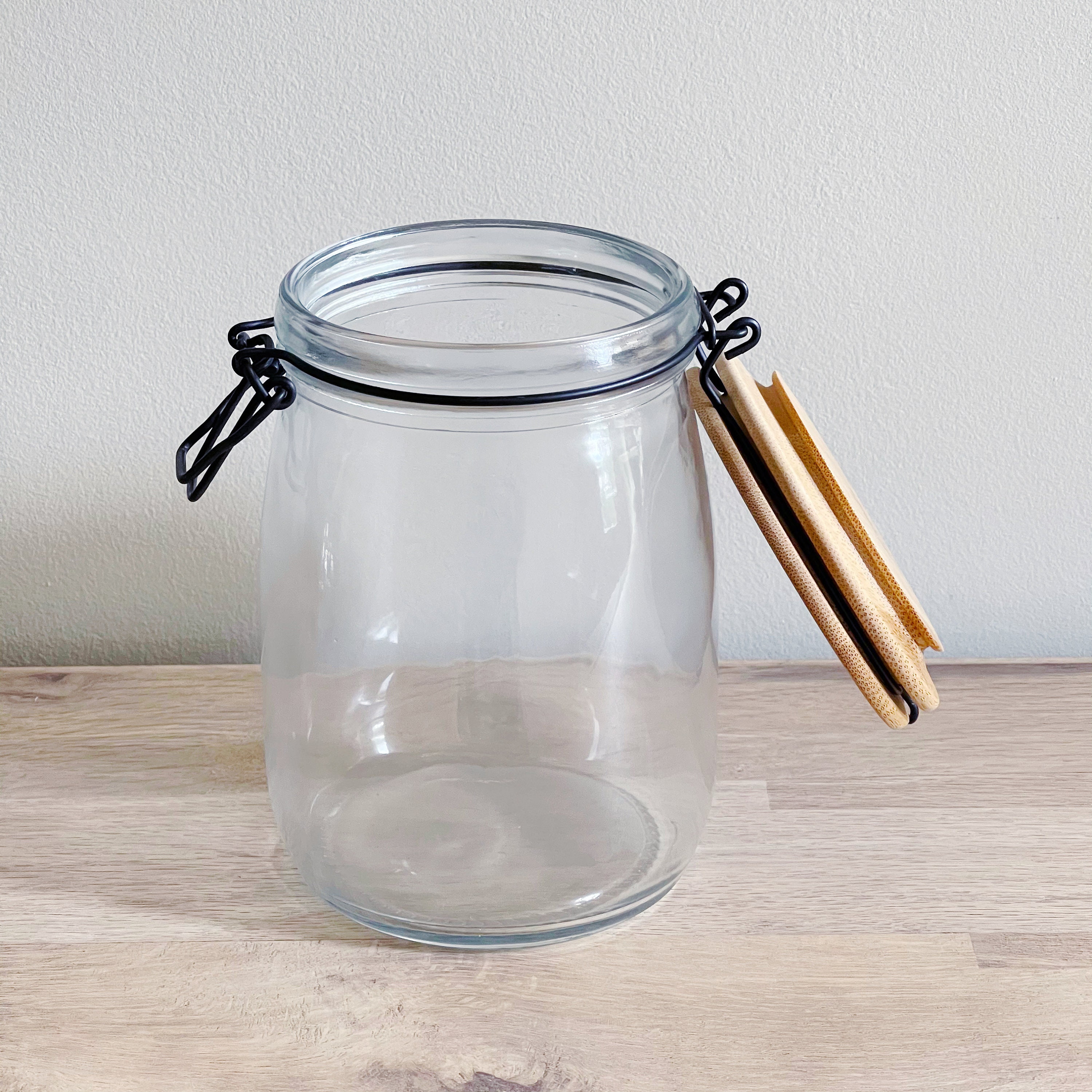 Clear Glass Storage Jar With Wooden Clip Lid and Black Metal