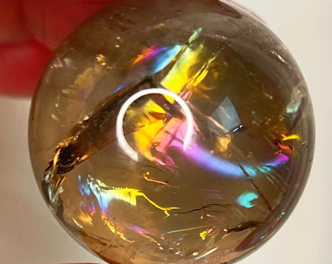 vivid rainbow smoky quartz sphere and translucent polished luster