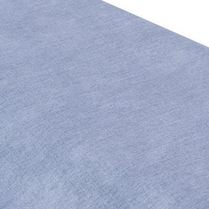 May include: A close-up of a light blue fabric with a subtle textured pattern.