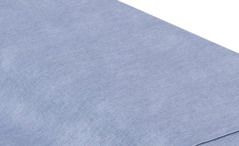 May include: A close-up of a light blue fabric with a subtle textured pattern.
