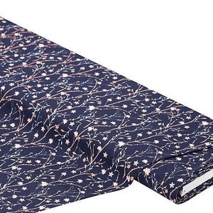 May include: Navy blue fabric with a white and pink floral pattern. The fabric is folded and rolled up.