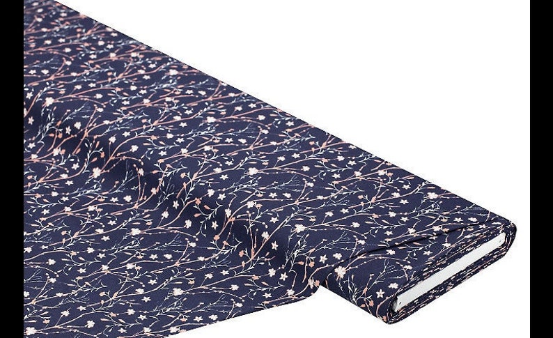 May include: Navy blue fabric with a white and pink floral pattern. The fabric is folded and rolled up.