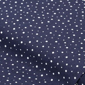 May include: A navy blue fabric with a white polka dot pattern.