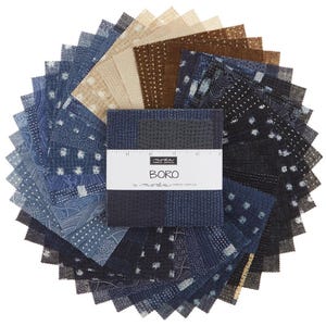 May include: A stack of square fabric swatches arranged in a circular fan pattern. The fabric features various shades of blue, brown, and cream with geometric and dotted patterns. A white paper band labeled "BORO by moda" wraps around the center.