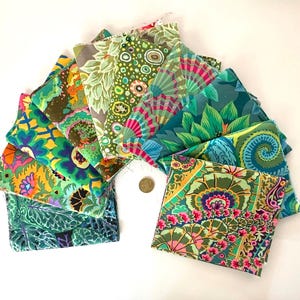 May include: A collection of colorful fabric squares with various floral and abstract patterns. The fabrics feature shades of green, blue, yellow, and pink. A coin is placed among the fabric squares.