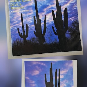 May include: Two copies of the August 1997 issue of Arizona Highways magazine. The cover features a desert landscape with silhouetted saguaro cacti against a blue and purple sky. The magazine's title is prominently displayed.