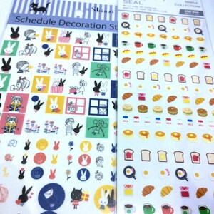May include: Two sheets of stickers. The left sheet has a variety of colorful stickers with images of bunnies, cats, flowers, and houses. The right sheet has a variety of stickers with images of food, including bread, eggs, milk cartons, and coffee cups. The text on the right sheet reads "One Point Seal Premium Simple Collection 150 yen".