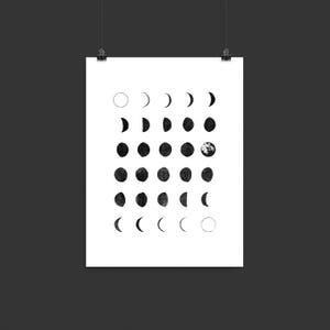 May include: A black and white illustration of the phases of the moon. The moon is depicted in various stages of its cycle, from a full moon to a new moon. The illustration is a simple and elegant design that would be perfect for a home decor piece.