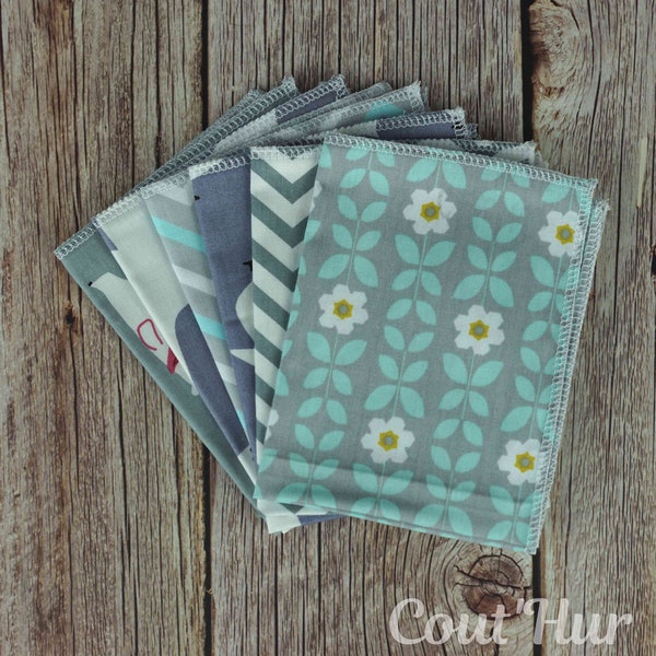 set of 6 medium-sized fabric handkerchiefs in shades of grey, turquoise blue and mint green with flower, penguin and bear motifs